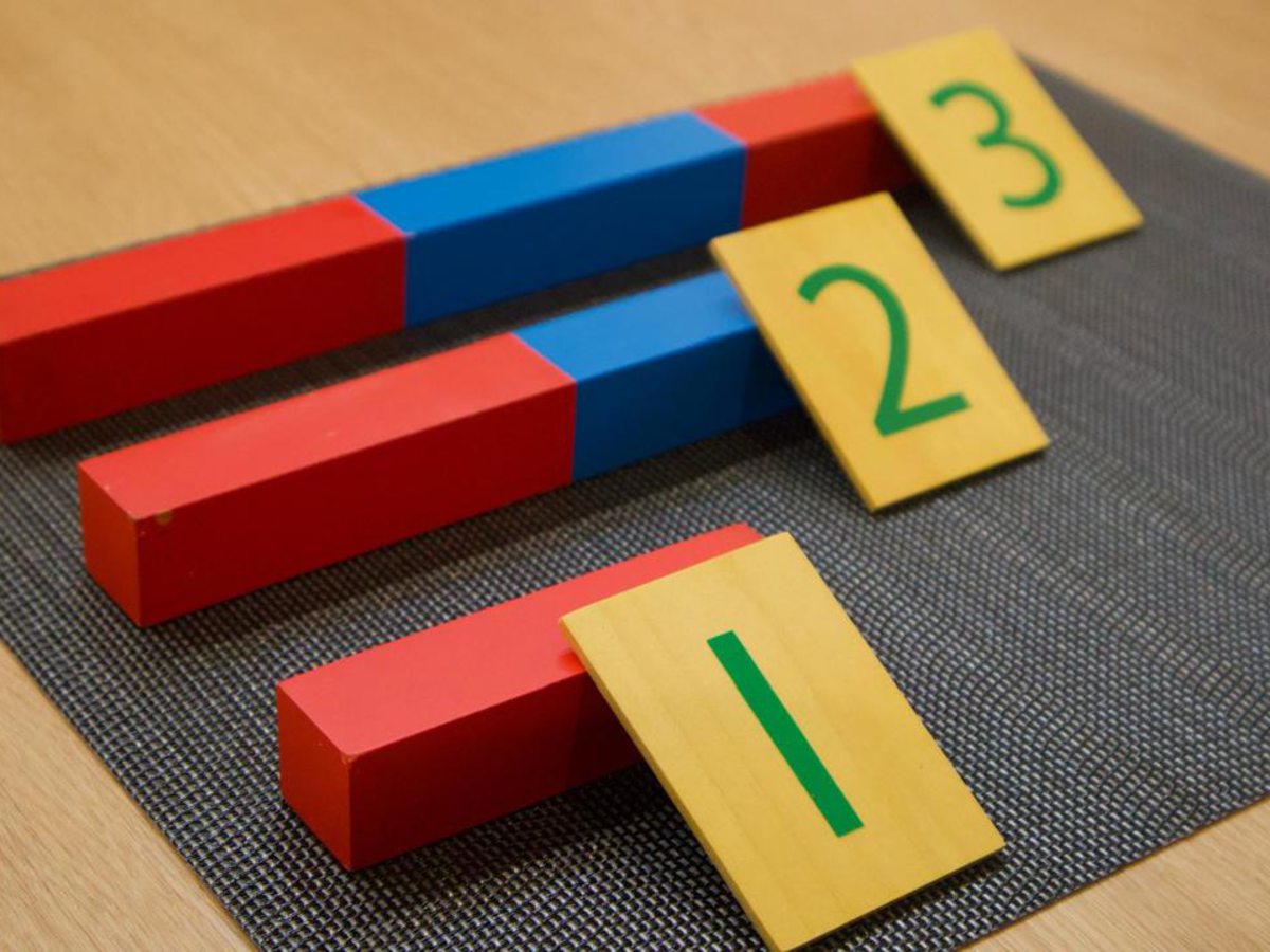 Montessori materials arranged on low, natural-wood shelves